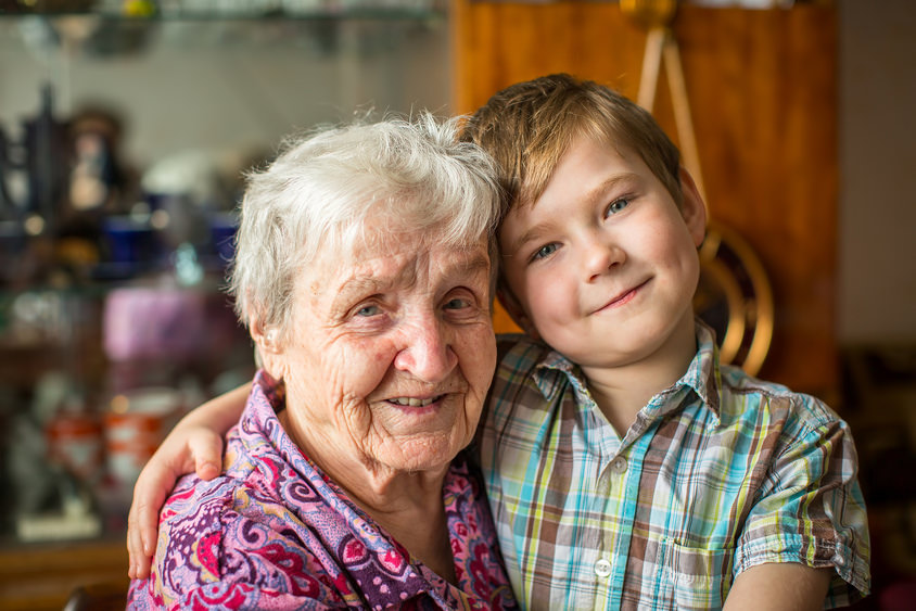 Portrait of an elderly woman with her little grandson.